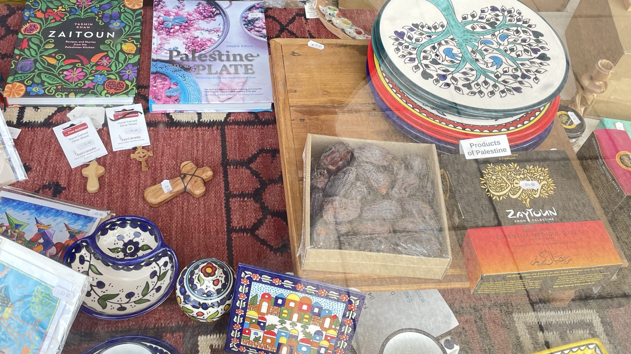 A selection of ceramics, books, and various little Palestinian products in shop window.
